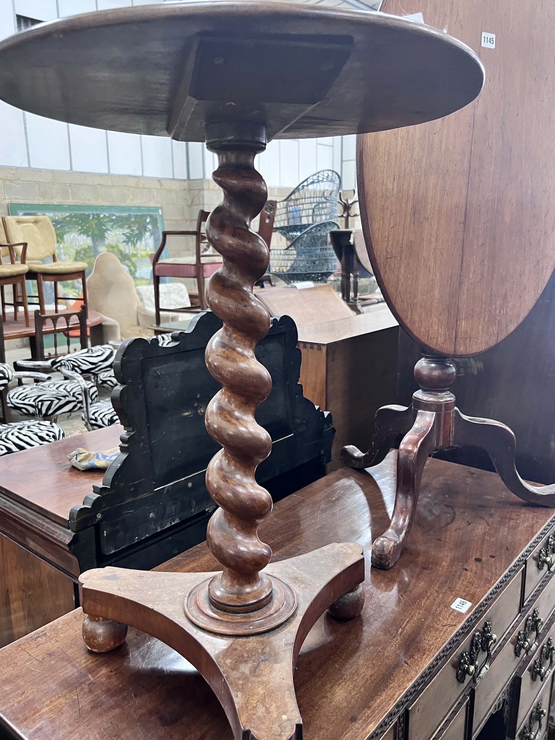 A Victorian spiral stem circular mahogany wine table, diameter 50cm, height 71cm, together with a Victorian oval mahogany tilt top tripod table